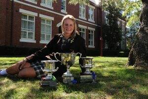Ballarat Grammar captain of boats Vicki Powell with the victorious rowing crew’s three trophies.
