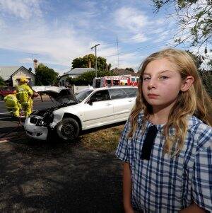 SCARE: Emma Collins in the driveway where she was almost hit by a car during a crash in Eureka Street yesterday.