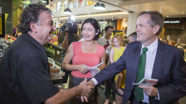 Fruiterer Jim Mousikos welcomes Opposition Leader Bill Shorten and Griffith Labor candidate Terri Butler to his fruit shop at Carindale. Photo: Glenn Hunt