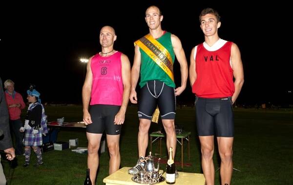 happy man: Nathan Fox stands on the winners podium after claiming the Ararat Gift on Saturday night, after chasing down his coach Robert Lehmann, left, who finished second, and Lachlan Dalgleish, third.