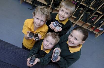 RECYCLERS: St Patrick's Primary School pupils, clockwise from left, Austin Smith, Dylan McPherson, Ella Krause and William Rothe helped collect more than 400 old mobile phones.