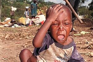File photo shows a Rwandan child crying as it sits in the dirt in a refugee camp in Ruhango.