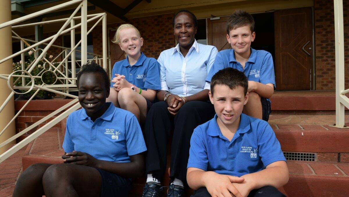 Understanding: Mary Wachira with Our Lady Help of Christians students Nyamal Nyak, Lilly Francis, Owen Pearse and Saxon Munday.