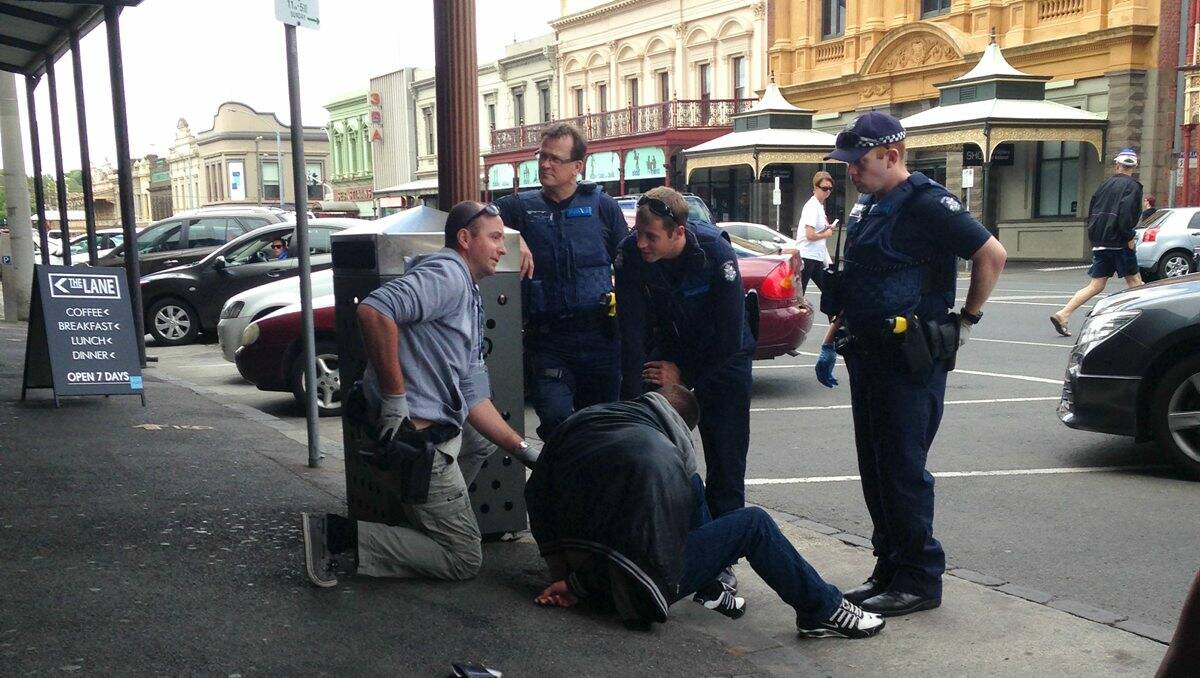Detained: Ballarat police attend an incident outside The George Hotel in Lydiard Street yesterday afternoon. PICTURE: Dellaram Vreeland