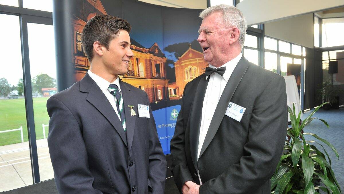 Past and present: St Patrick’s College football captain Liam Duggan chats with 1957 Brownlow medallist Brian Gleeson. PICTURE: LACHLAN BENCE