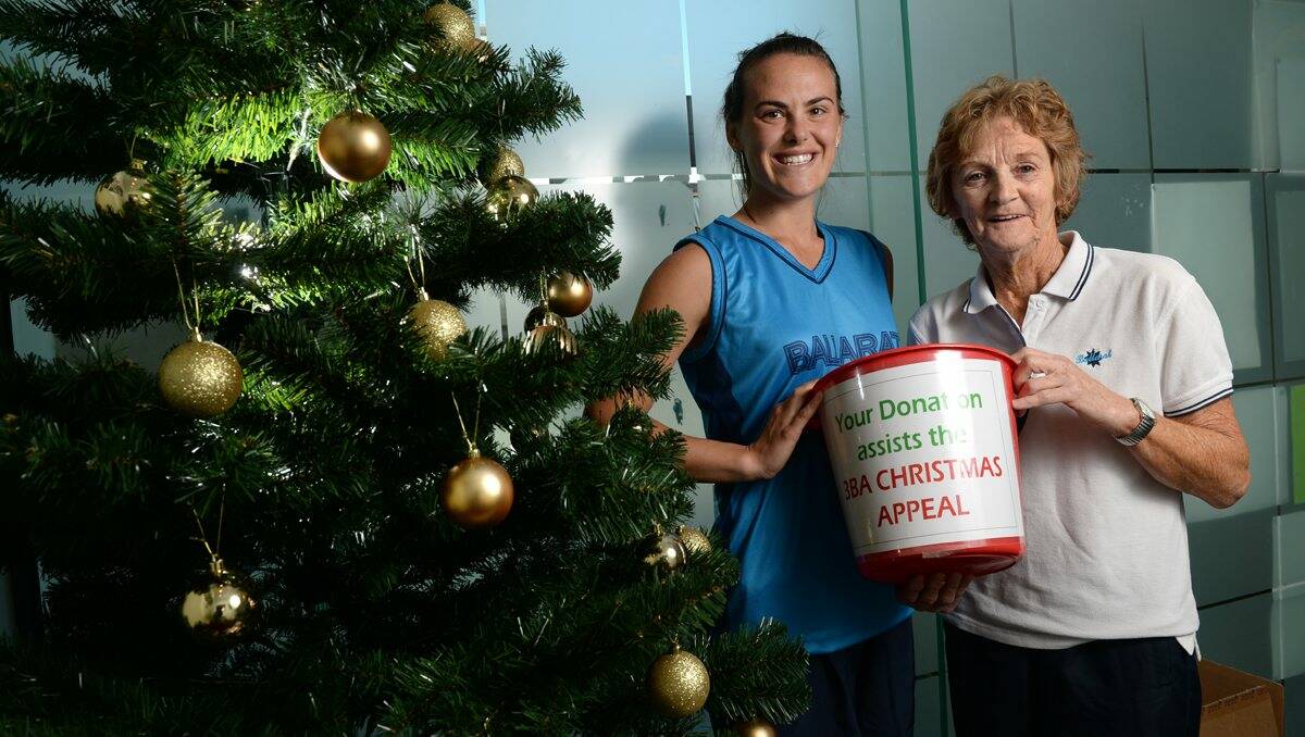 Helping out: Cassie Peace and Reet Lenaghan add Ballarat Netball Association’s donation to the appeal. PICTURE: ADAM TRAFFORD