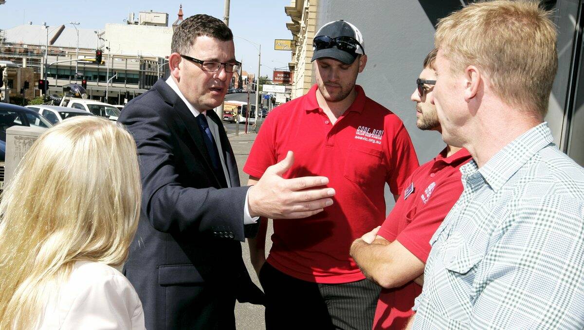 Strained relations: Sharon Knight and Daniel Andrews with paramedics Adam Phillips, Mitch Ridgway and Barry Brennan.