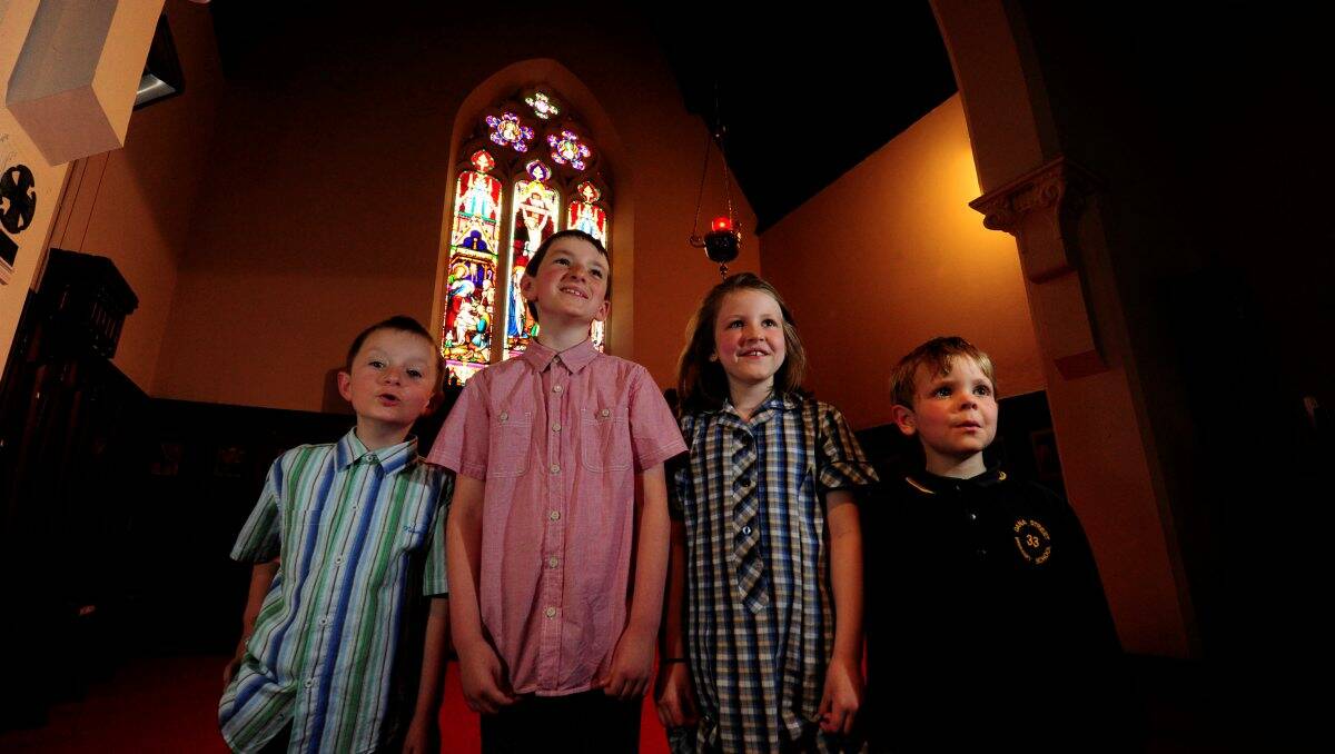 Songsters: Junior choristers Leopold and Sebastian Allen and Miranda and Charlie Hann are looking forward to singing some Christmas carols as part of the Christ Church Anglican Cathedral’s service. PICTURE: JEREMY BANNISTER