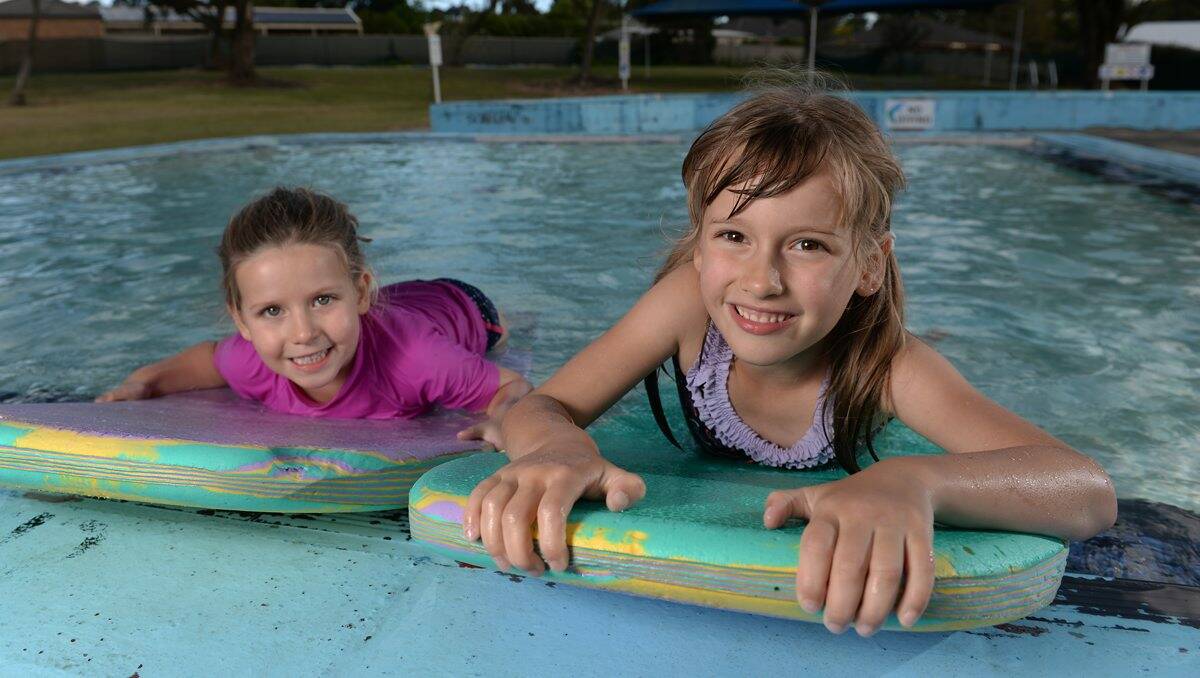 GOOD TIME: Maggie and Charlotte Peele test out the Buninyong pool which, is due to open on Saturday. PICTURE: ADAM TRAFFORD