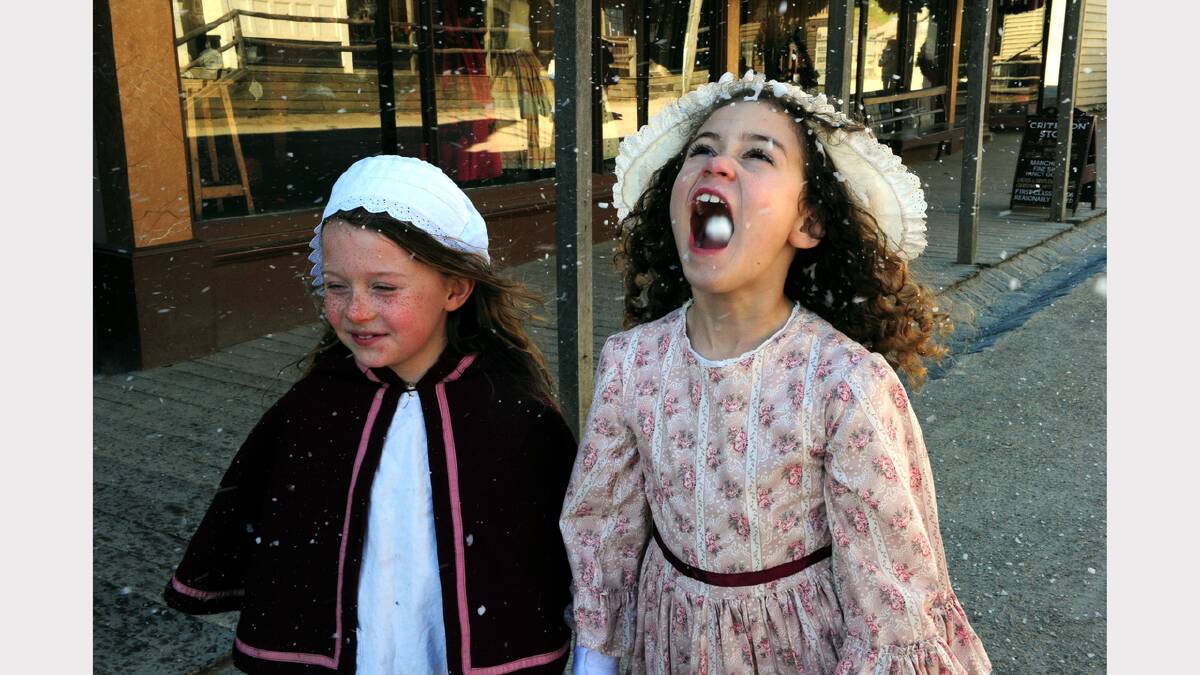 Christmas in July at Sovereign Hill. Clare Williams and Ella Sevior enjoying the snow. PHOTO: JEREMY BANNISTER