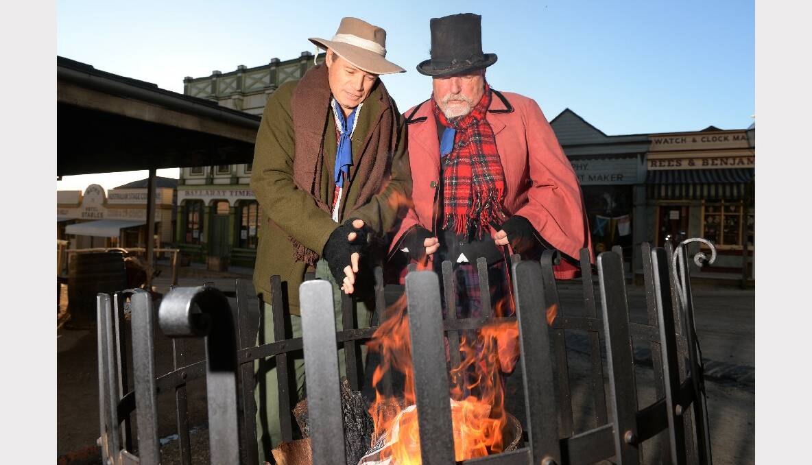 Sovereign Hill Workers, Mark Filmer and Ian Burton trying to keep warm in the cold weather.  PHOTO: KATE HEALY