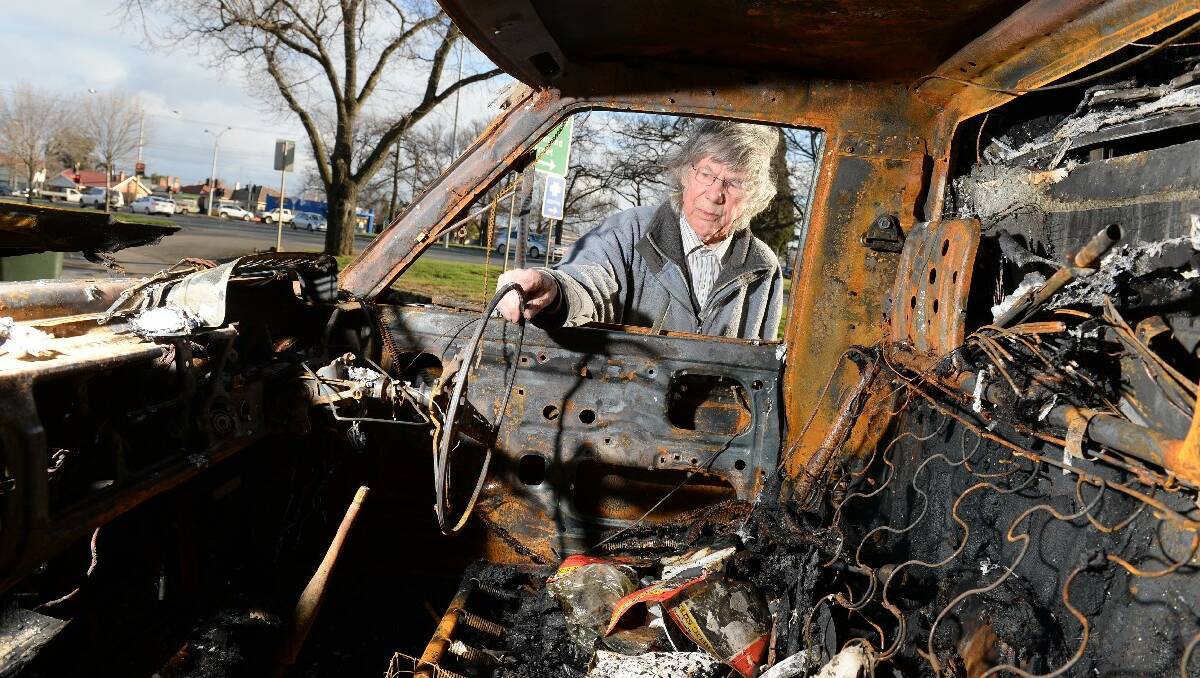 Victor Kirby with his torched car.