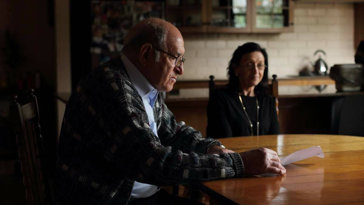 STRENGTH: Louis Pirona, with his sister Angela Barry,  reads a letter from then-Prime Minister Julia Gillard to journalist Joanne McCarthy. 