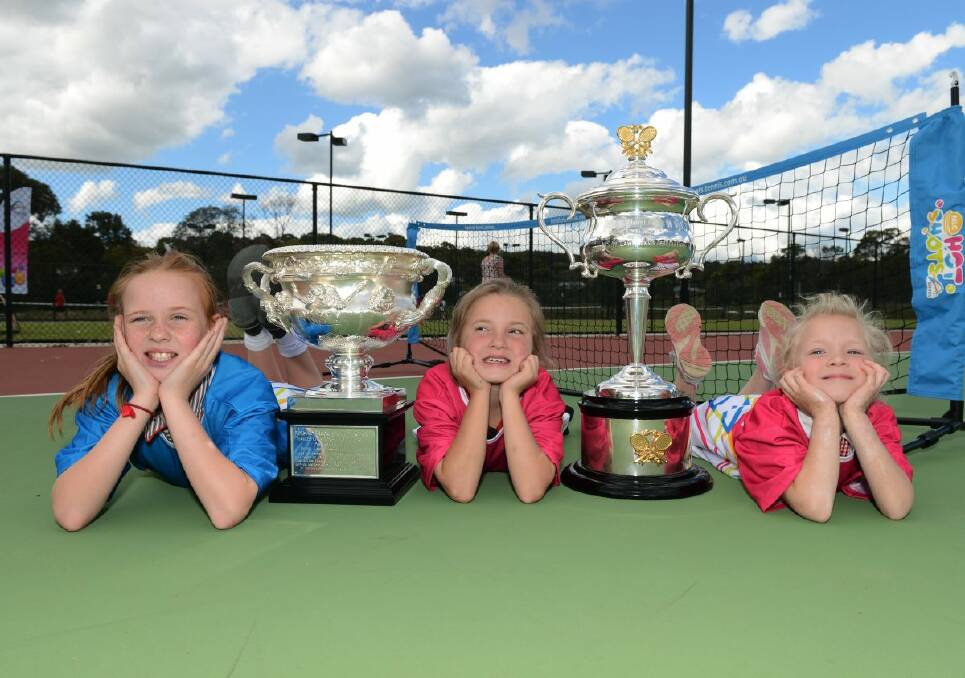Olivia Moneghetti ,9, Hannah Crawley, 8, and Abby Crawley, 6, with the Australian Open 2013 trophies at Buninyong yesterday. 