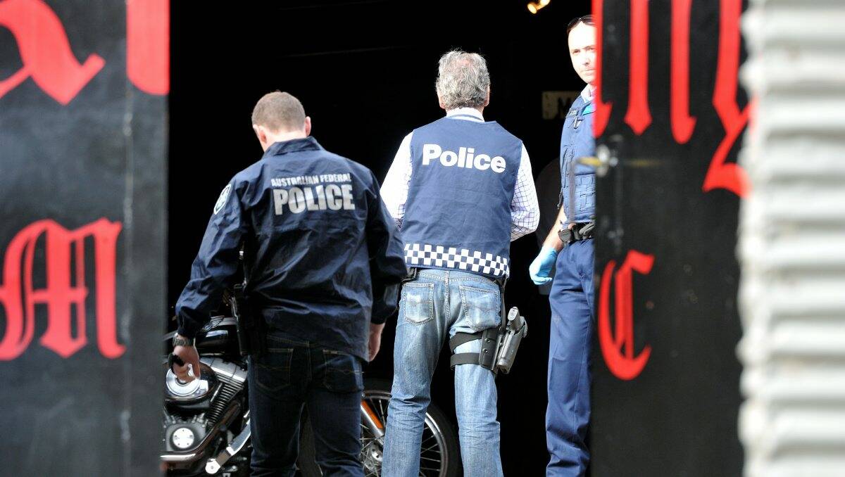 RAID: Police at one of the bikie clubs yesterday