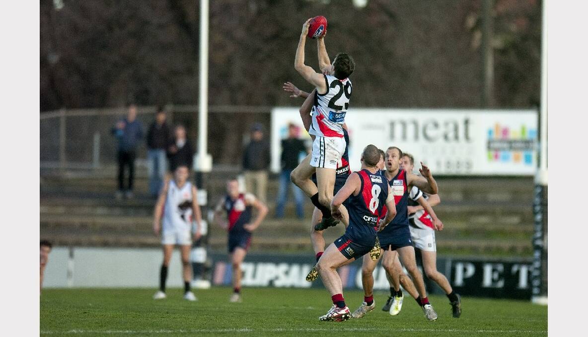 Roosters' backman Michael Searl climbs high for his mark against Coburg. PICTURE:  Shane Goss, THE LICORICE GALLERY. 
