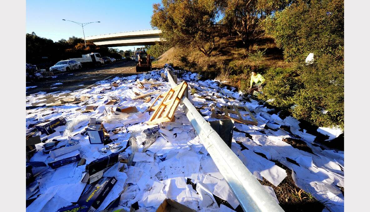 Parcels and paper are strewn over the freeway after a B-double truck rolled this morning. PHOTOS: JEREMY BANNISTER.