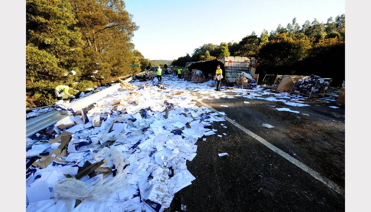 Parcels and paper are strewn over the freeway after a B-double truck rolled this morning. PHOTOS: JEREMY BANNISTER.