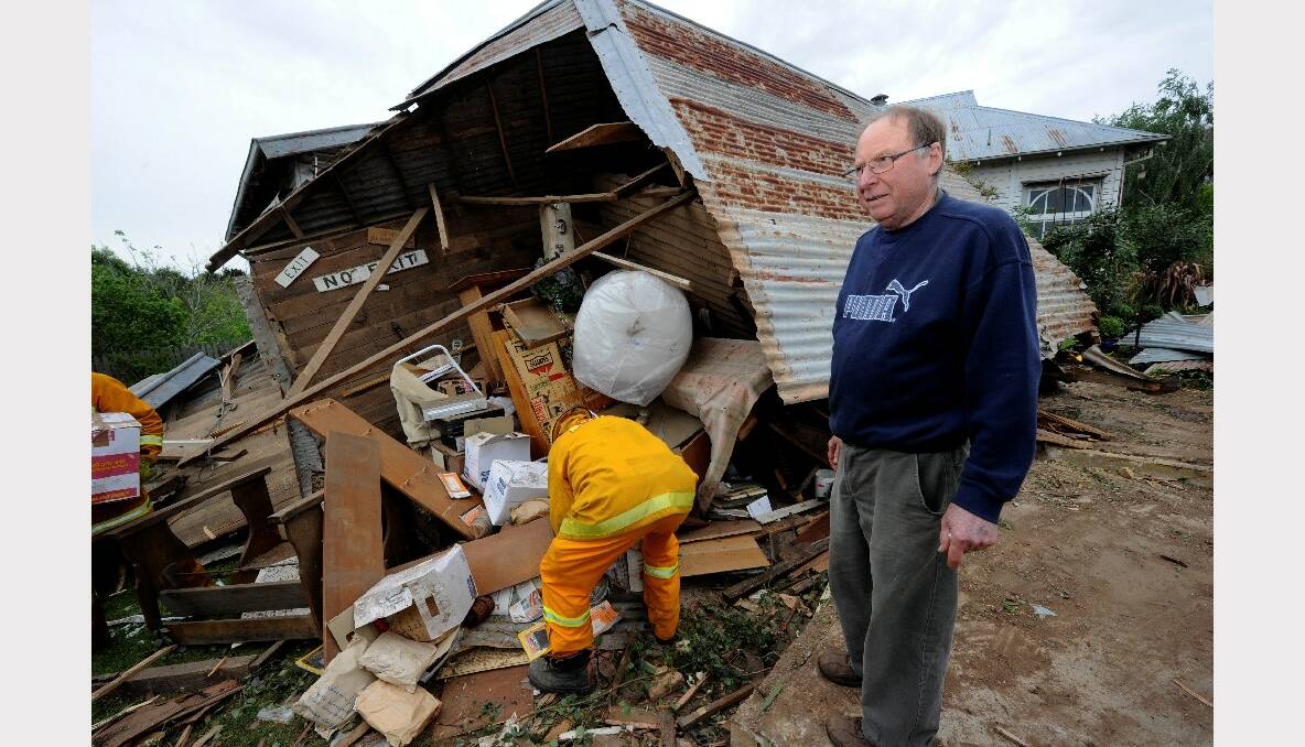 John Hungerford looks over the damage left after a truck crashed through the Newlyn Antique Shop on the Midland Highway. PICTURE: JEREMY BANNISTER.