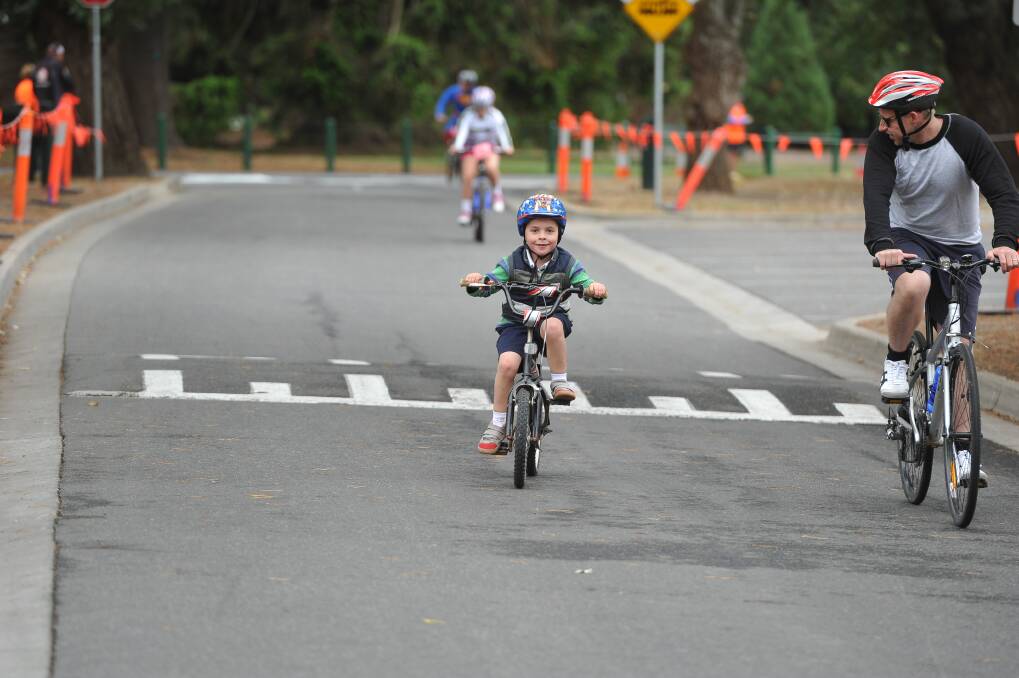 Cyclists cross the line. PIC: Lachlan Bence