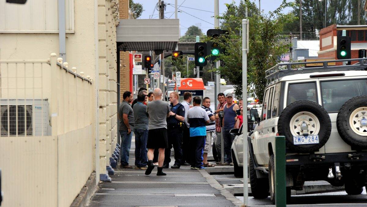 Police interview witnesses at the scene yesterday. Picture: Jeremy Bannister