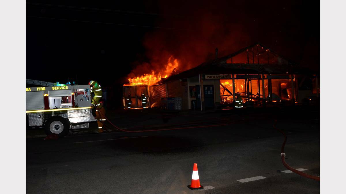 Firefighters battle the blaze which destroyed the Wilmot Country Store early yesterday. Picture: Andrew Hill. 