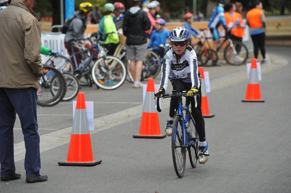 Cyclists cross the finish line. PICTURES: Lachlan Bence