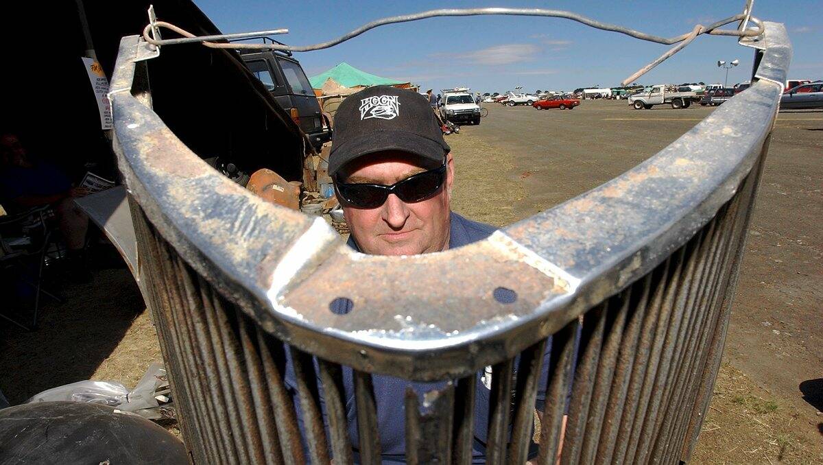 2004.  Ian Hardman with a '36 Ford grill. Ian has been going to the swap meet every year for the past 15 and sets up on the same site.