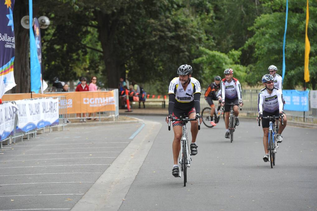 Road race cyclists cross the line. PIC: Lachlan Bence
