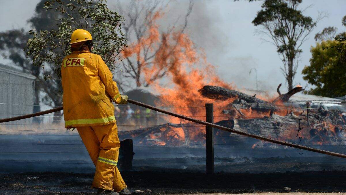 Fire fighters battle Tuesday's grass fire at Alfredton. Picture: Adam Trafford