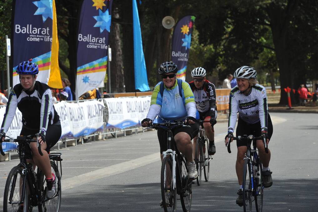 Road race competitors cross the line as crowds watch on. PIC: Lachlan Bence