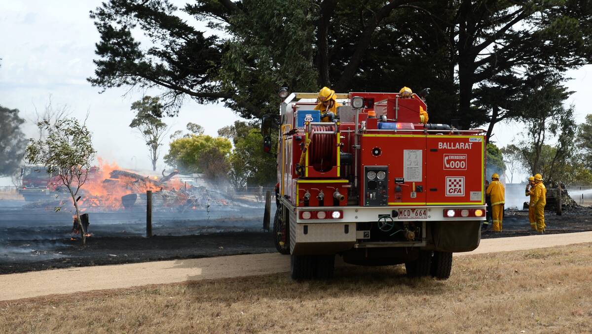 Crews work to put out the blaze. Picture: Adam Trafford