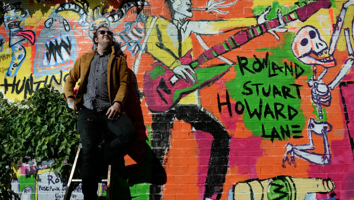Ballarat artist Casey Tosh in the unnamed laneway he's dubbed "Rowland Stuart Howard Lane". PICTURE: ADAM TRAFFORD