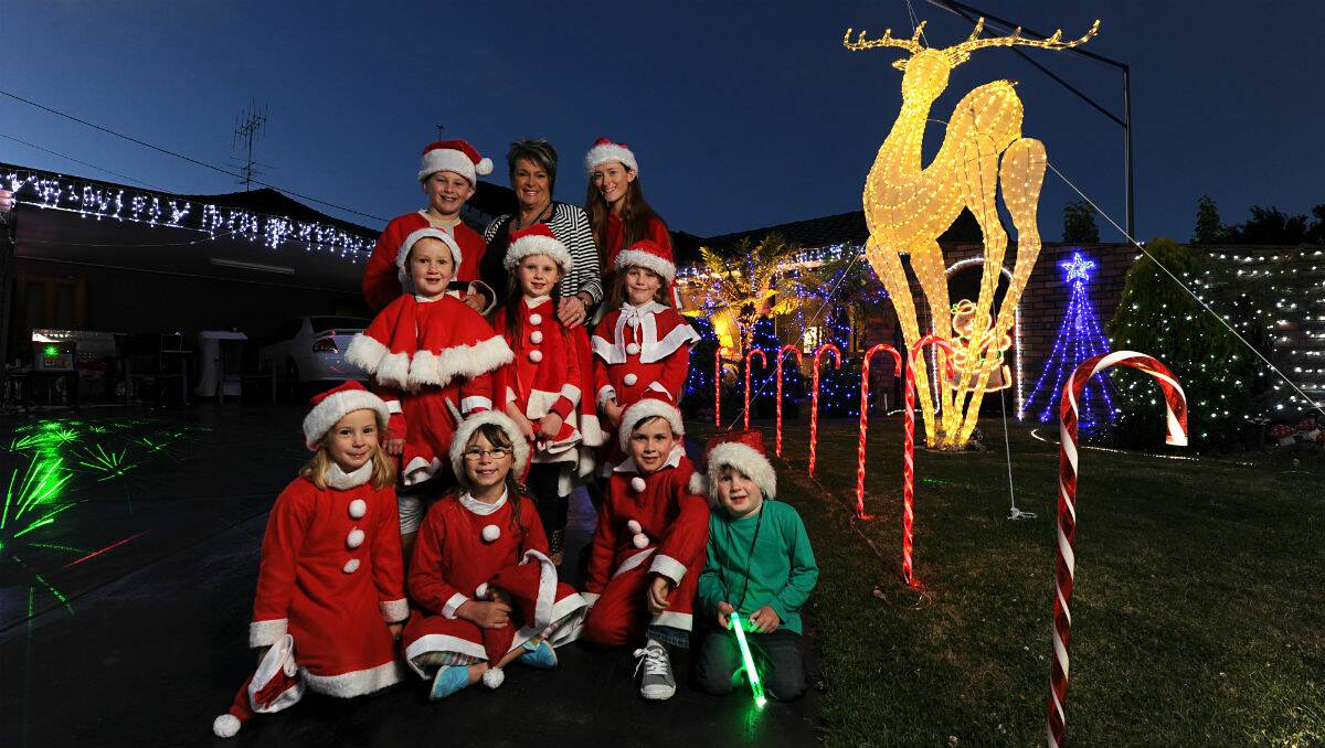 The Gilbert family and friends in front of the winning Christmas lights display. PICTURE: JUSTIN WHITELOCK