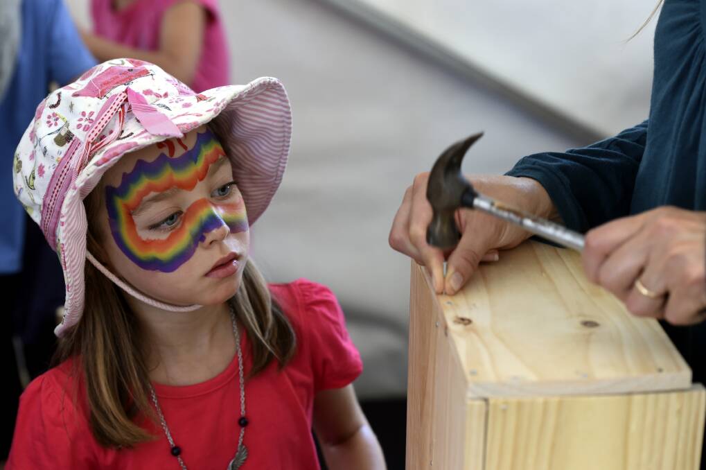 Maia Draper watches the construction of a birdbox in the woodworking area PIC: JEREMY BANNISTER 