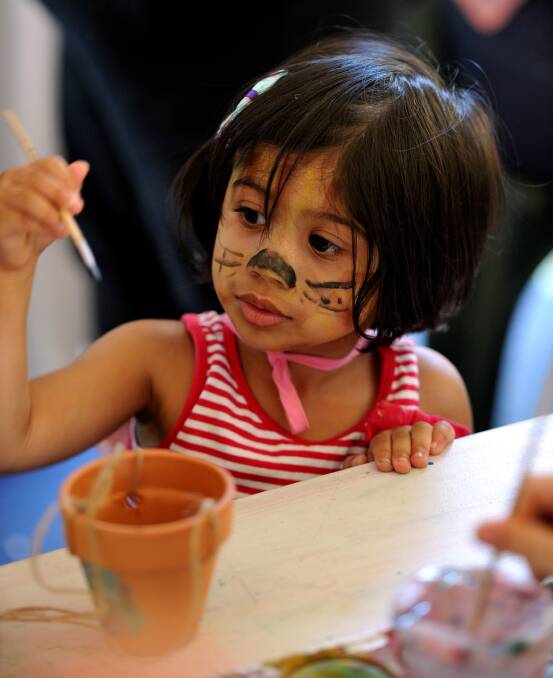 Aaliyah Bhatte paints up her pot - Begonia Festival day two  PIC: Jeremy Bannister