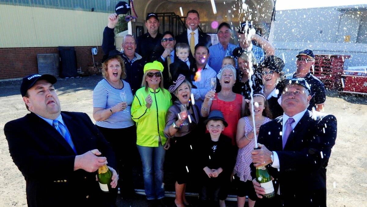 Darren Woodyatt and Graham Biggs, along with other part-owners of Dandino, toast their hoped-for success the Melbourne Cup.