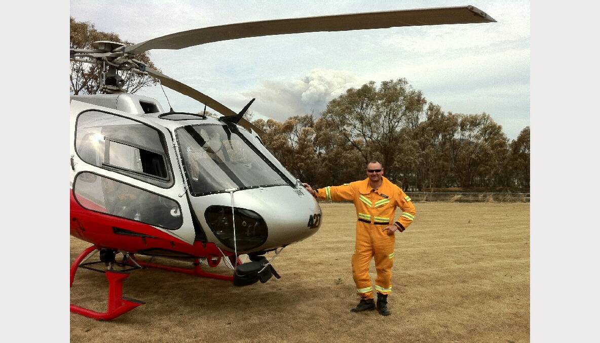 Wayne Rigg next to a AS350 B2 - Squirrel Helicopter in Tasmania. 