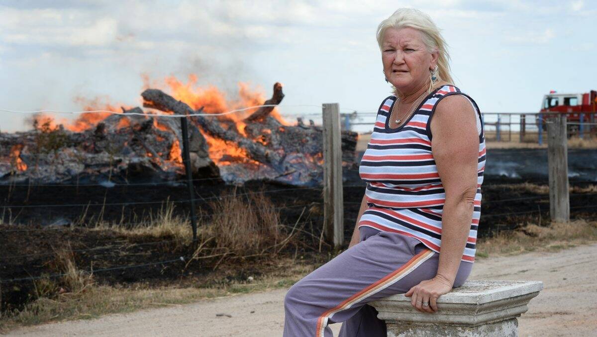Katrina Fitzpatrick keeps watch on the fire at Cardigan which came within metres of her home yesterday. PICTURE: ADAM TRAFFORD 