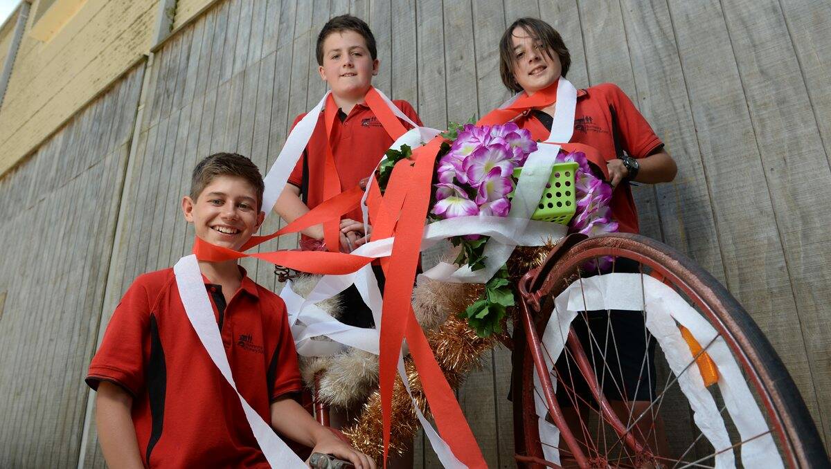 Buninyong Primary School pupils Joel Boucher, 12, Max Wood, 11, and Corbin Forsyth, 12, are busy decorating their bikes before the Cycling Australia Road National Championships. PICTURE: ADAM TRAFFORD