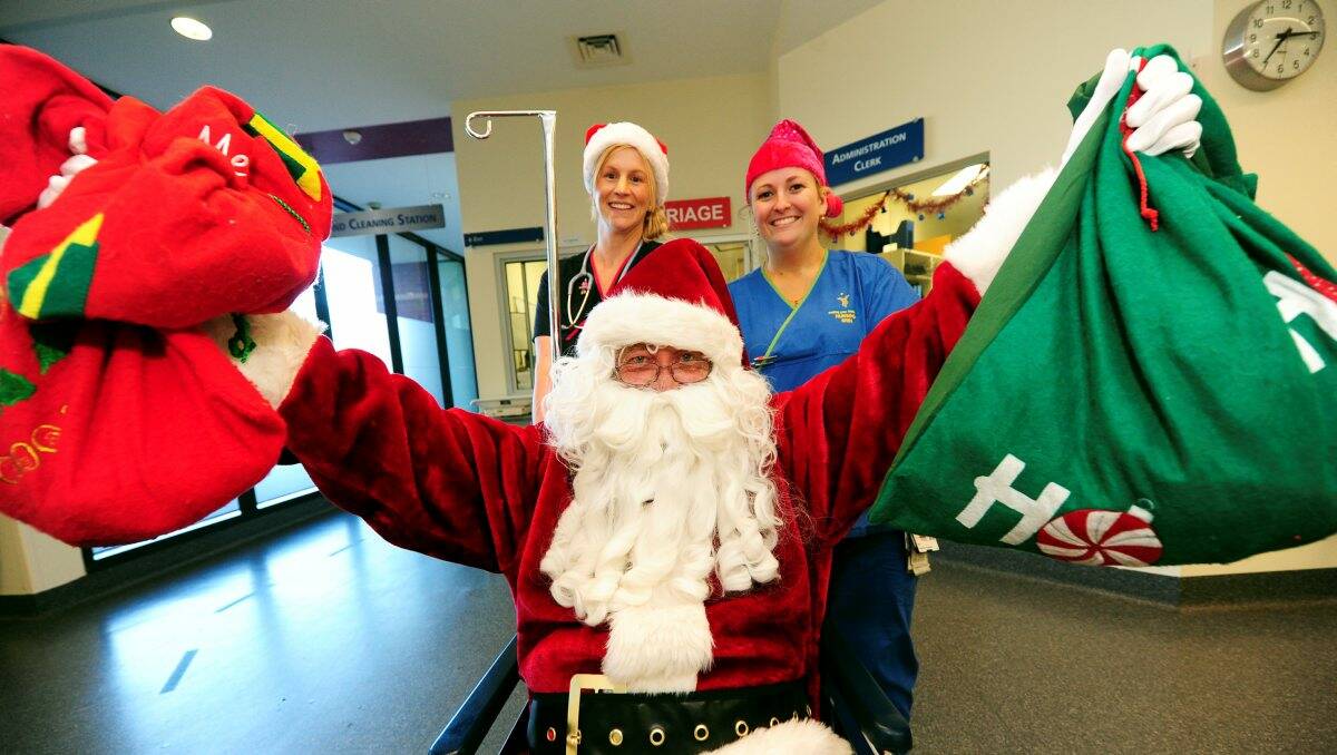 Santa (aka Krusty Keene) with BHS nurses Kara Elson and Erin McKenzie. PICTURE: JEREMY BANNISTER