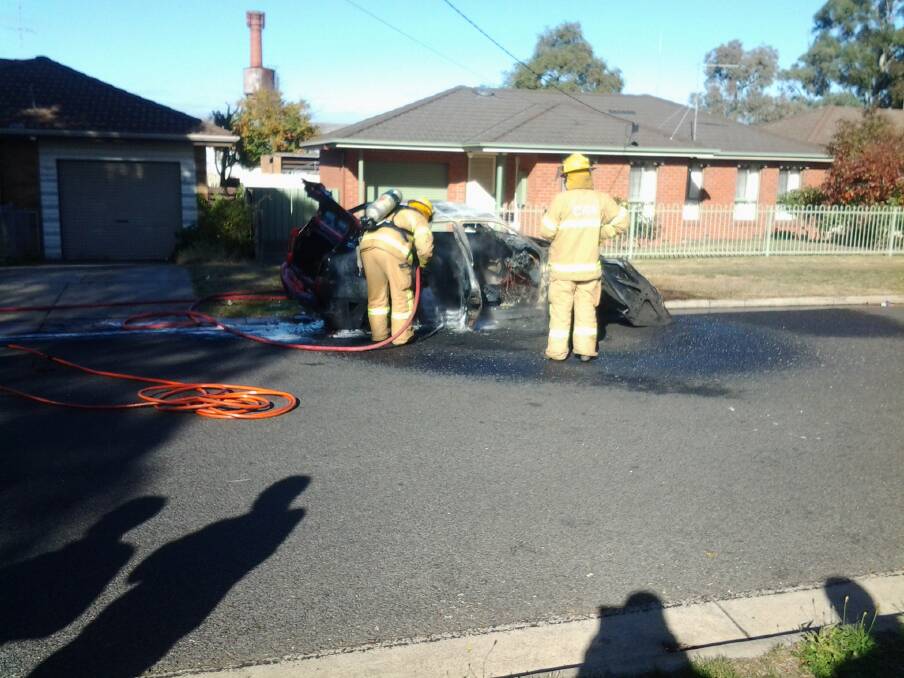 Firefighters put out a car fire on Paling St. PHOTO: Darren Exon.