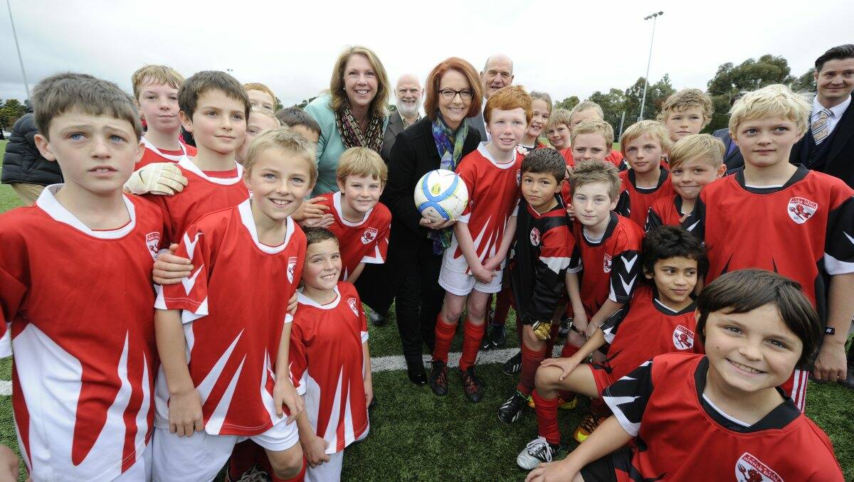 Prime Minister Julia Gillard and Regional Services Minister Catherine King with the Ballarat Junior Red Devils soccer club PHOTO: Justin Whitelock