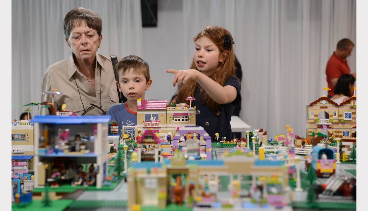 Annemarie Foletta looks at some work with Harry Segal, 5, and Serena Segal, 8. PICTURE: ADAM TRAFFORD