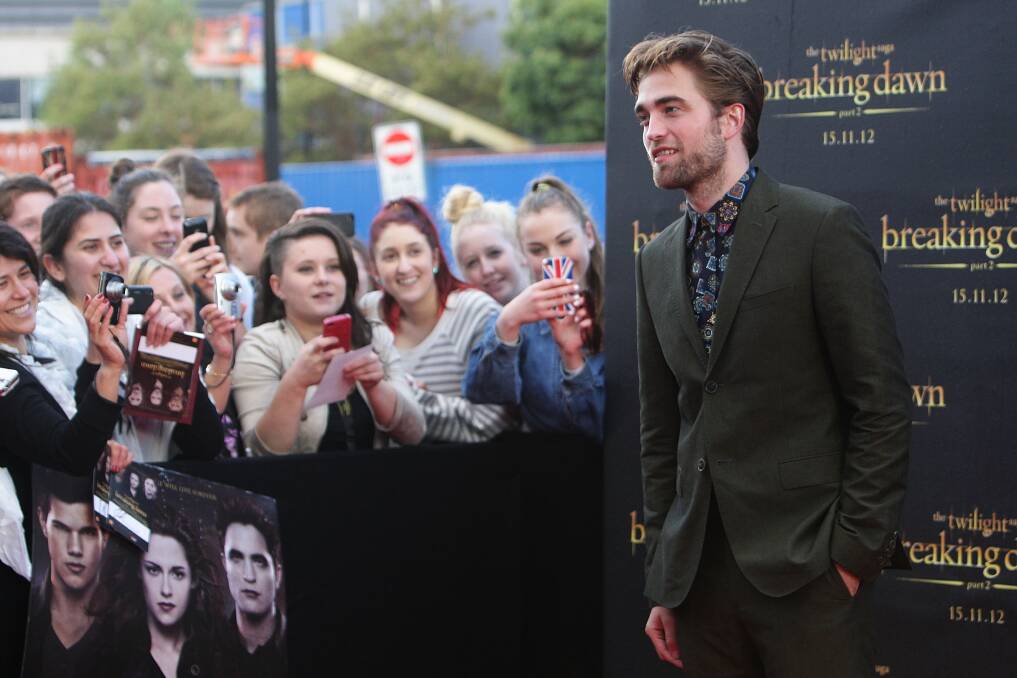 Robert Pattinson poses with fans during a 'Breaking Dawn - Part 2' fan event at Fox Studios on October 22, 2012 in Sydney, Australia. Photo by Lisa Maree Williams/Getty Images