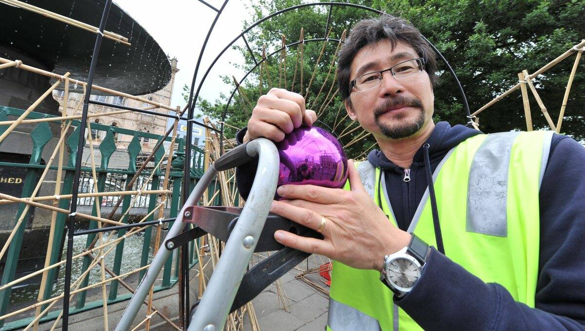 Artist Shoso Shimbo helps transform the Burke and Wills Fountain in Sturt Street into a Christmas display as part of a public project. 