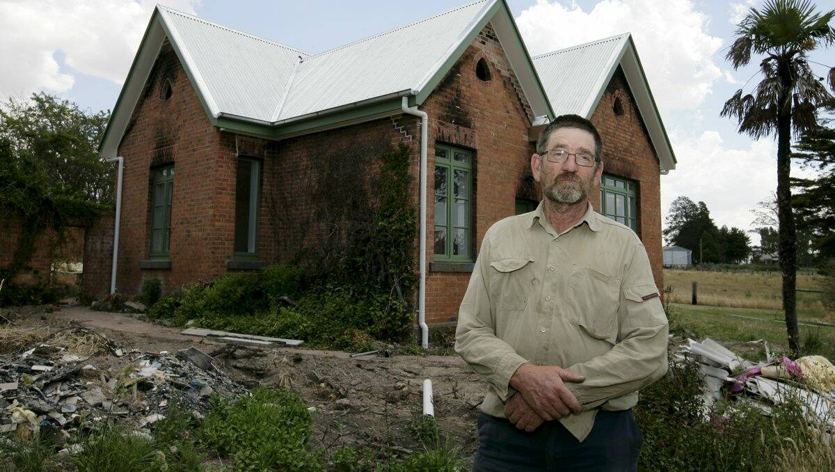 Carngham Station property manager Glenn Bird and (inset) the historic homestead going up in flames one year ago.