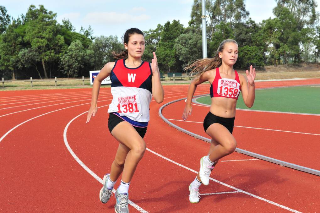 Sisters Grace, left, and Holly Nichols prepare for the Victorian Country Track and Field Championships in Ballarat.