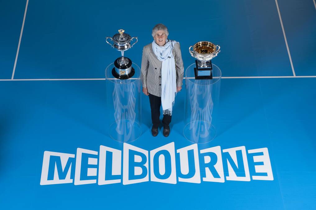 Judy Dalton poses with the men's and women's Australian Open trophies during the announcement that she is to be inducted into Tennis Australia's Hall of Fame. PICTURE: TENNIS AUSTRALIA 