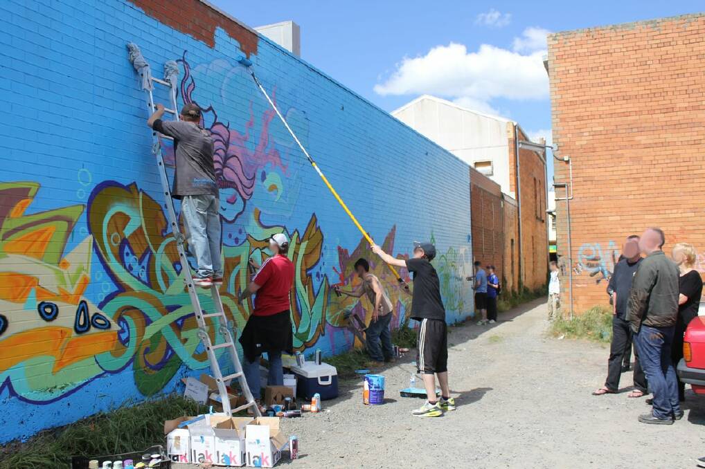 The group works on a wall in a rear carpark off Armstrong Street, Ballarat, in which they had permission to do. 